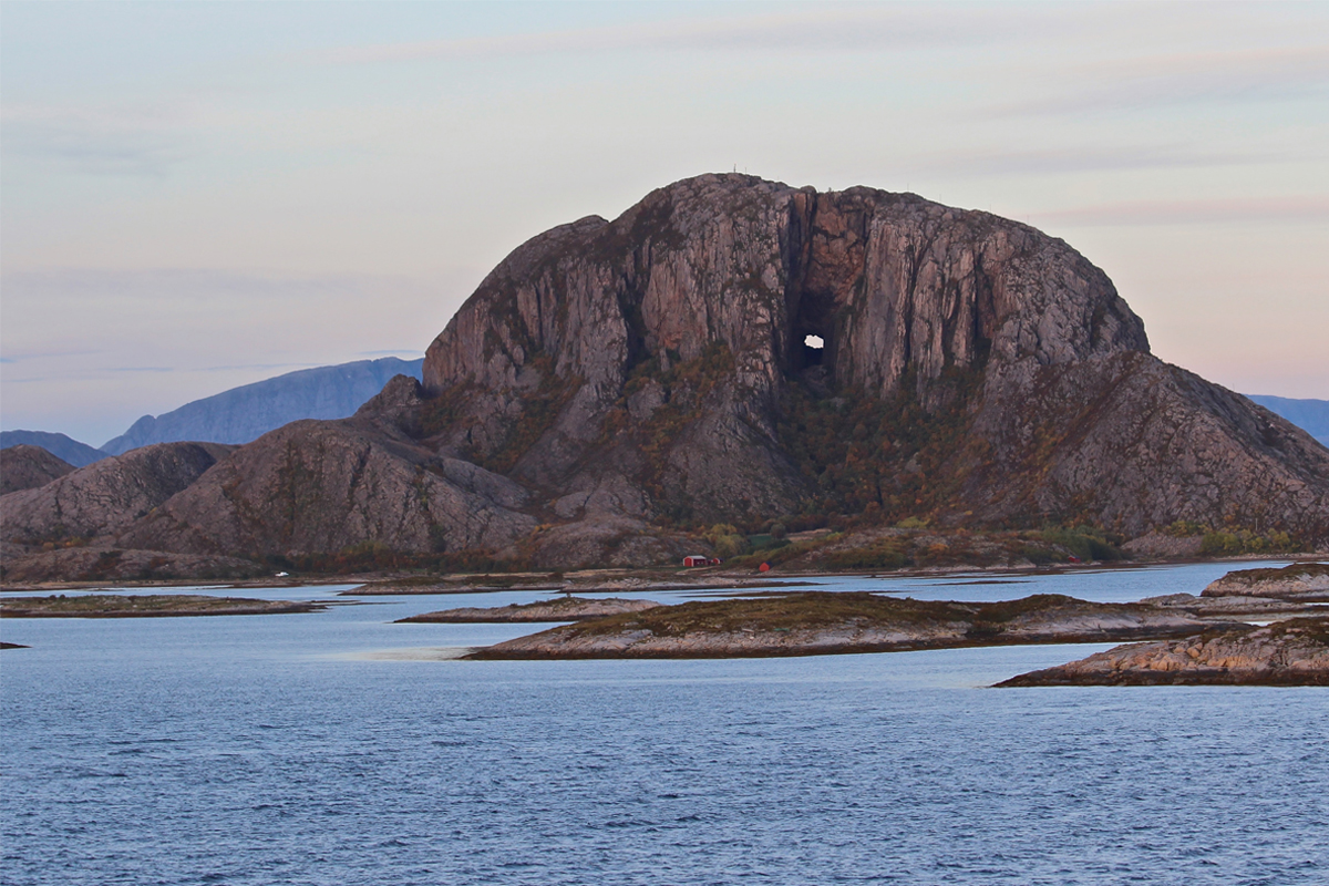 Mountain with a round hole going through the middle of the mountain